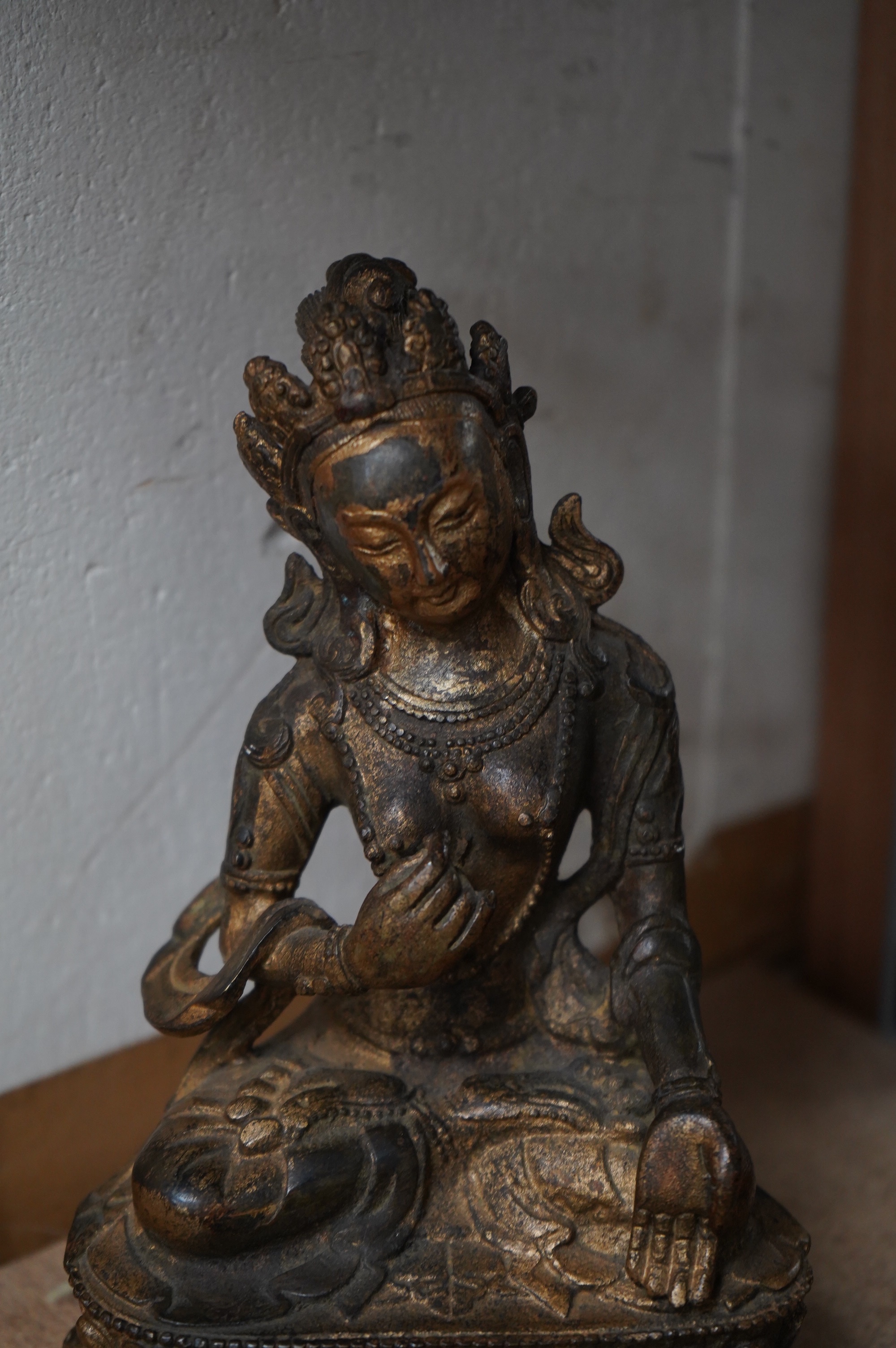 A Tibetan gilt bronze figure of seated Tara, on a double lotus throne, 16.5cm high. Condition - good